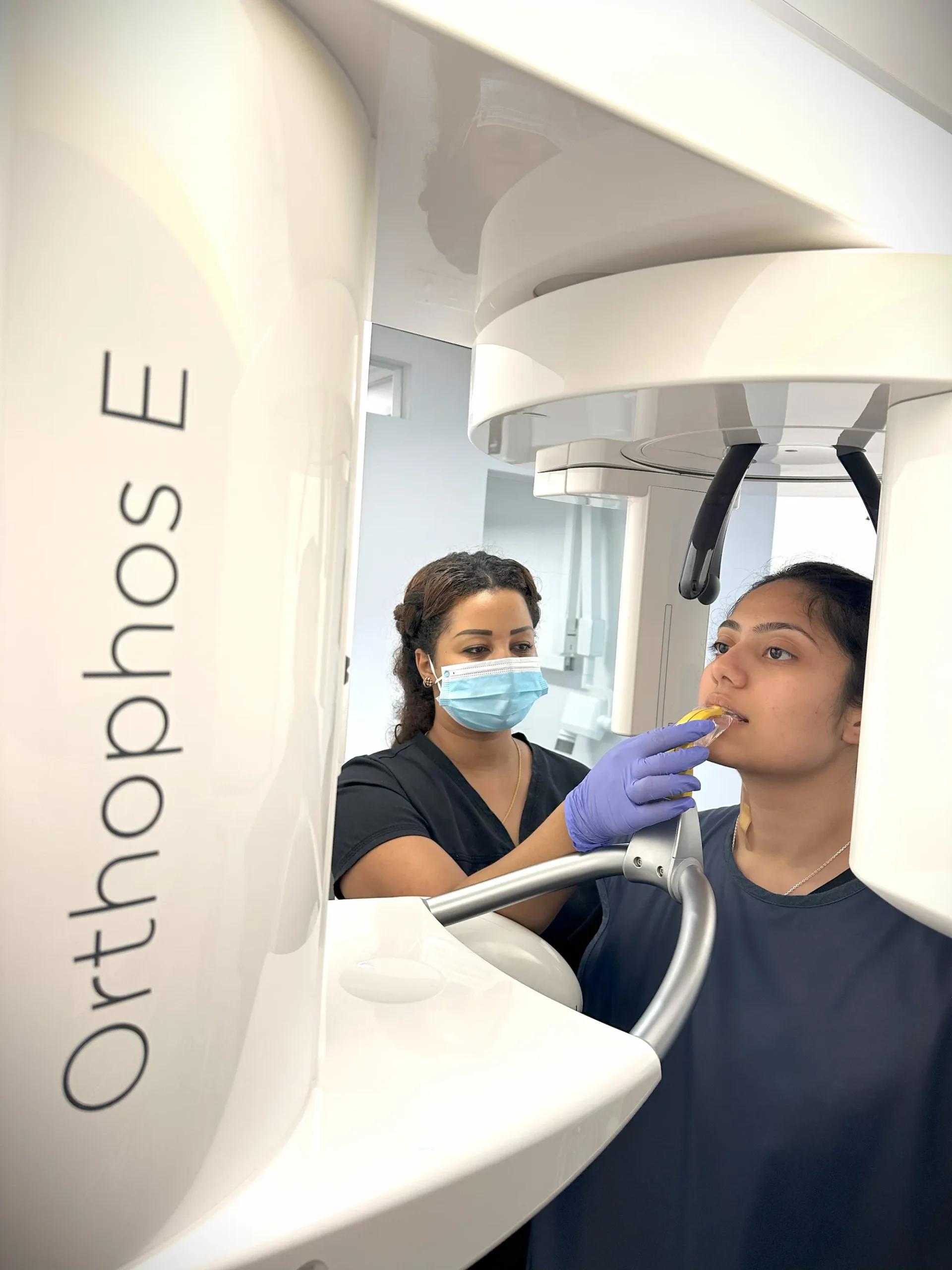 Dental professional positioning a patient for a panoramic X-ray scan