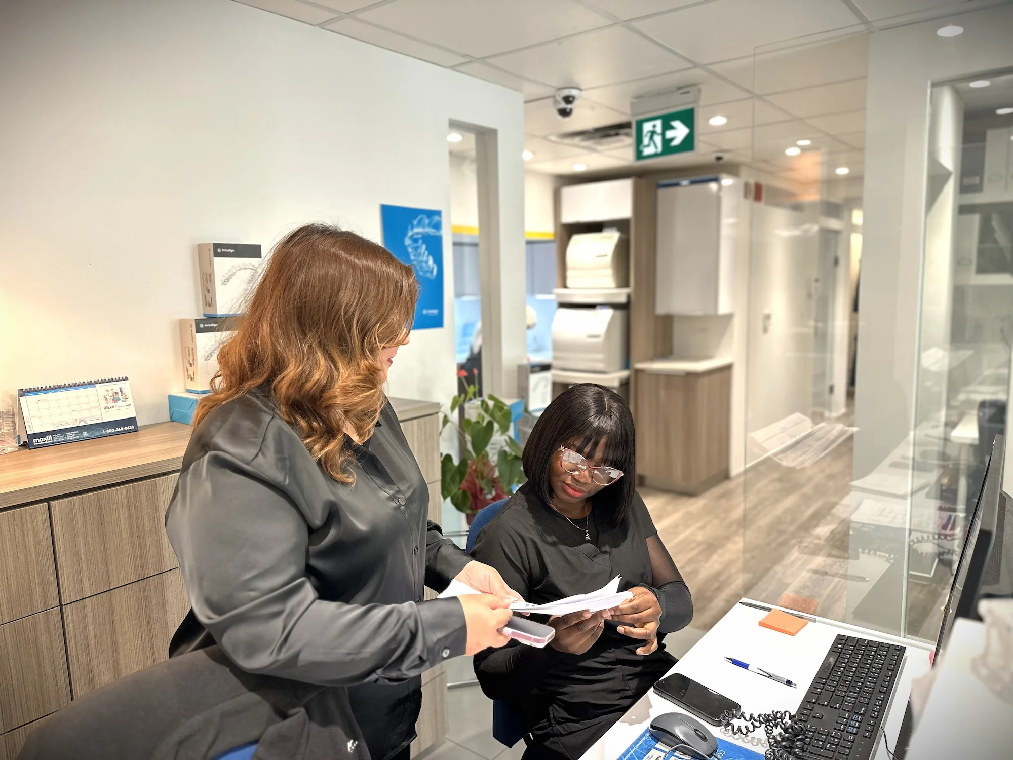 Hayden Charles Dental Care team reviewing patient documents at reception