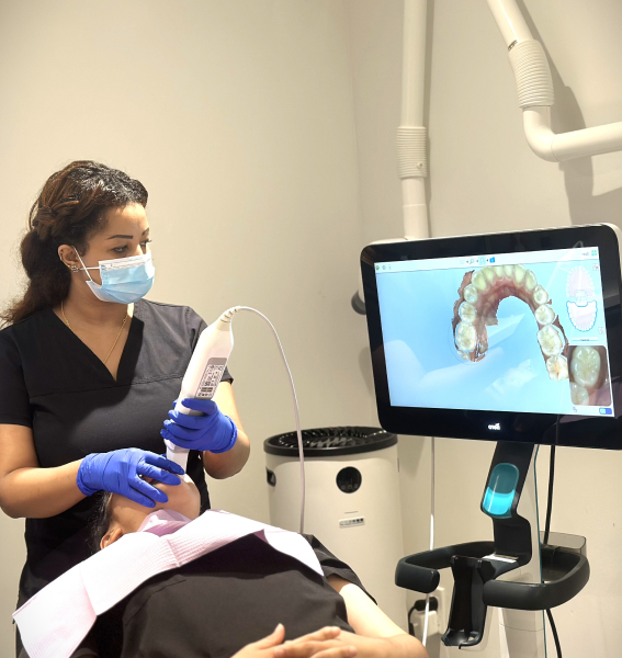 Dental professional using an iTero digital scanner with a patient
